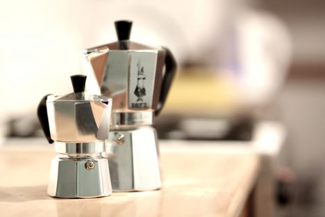 Two Moka pots, together on a counter.