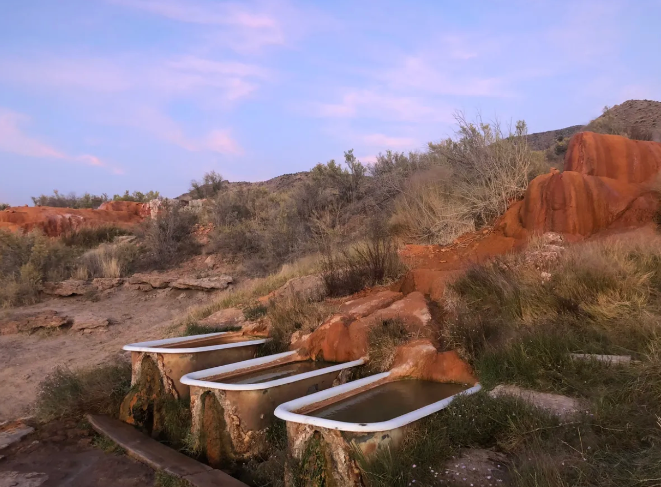The vintage clawfoot bathtubs are set right into the hillside.