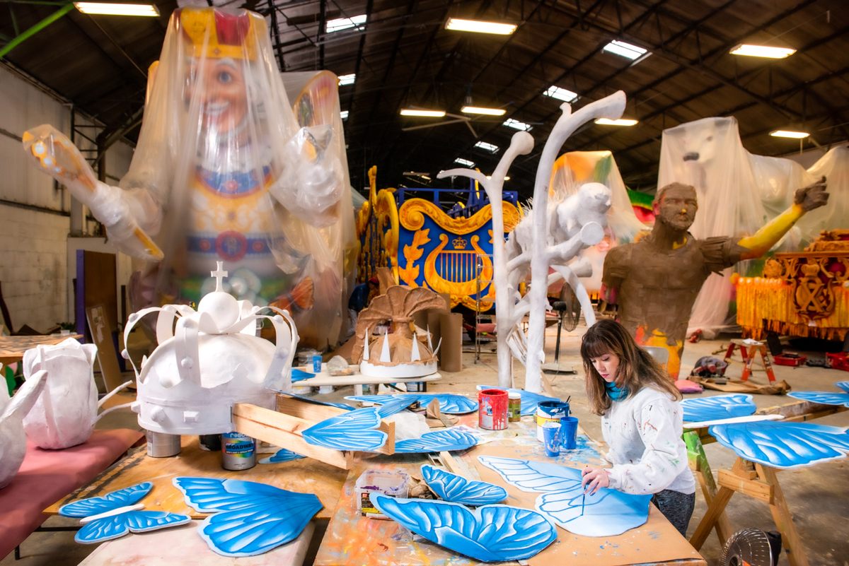 Royal Artist Ariel Troxclair paints butterflies for the "Butterflies of Winter" house float for the gallery of jewelry designer Mignon Faget.