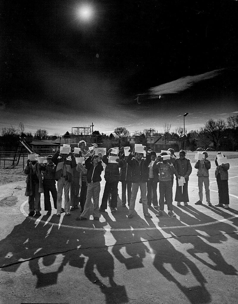 Pupils at a school in Denver watch projections of the solar eclipse, 1979. 