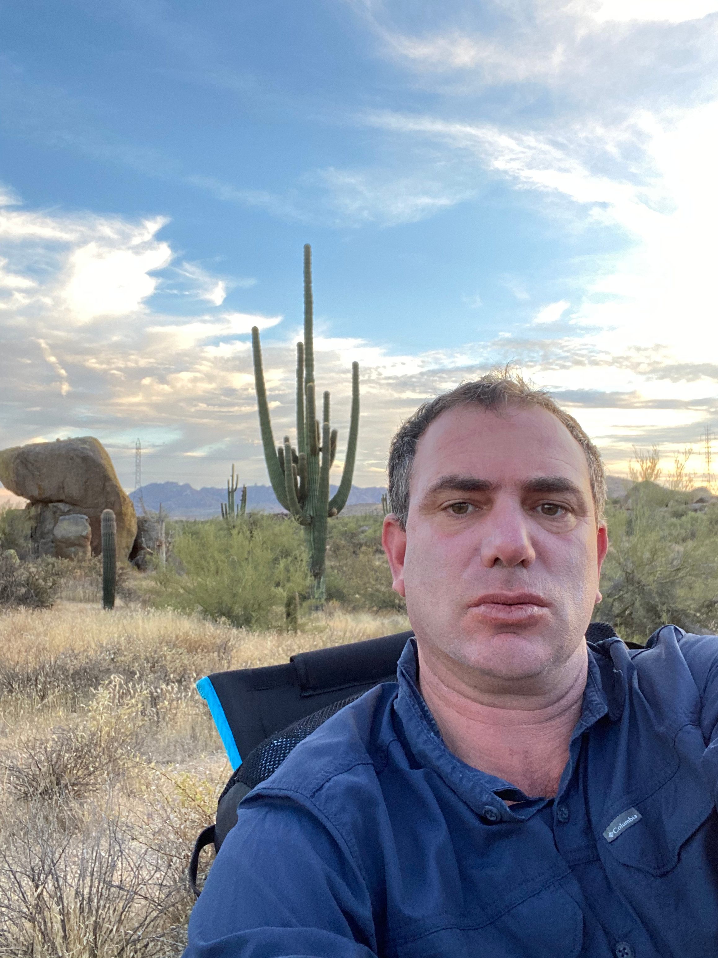 Flouting his own prohibition on digital devices while extreme sitting, Silk snaps a selfie as he sits in McDowell Mountain Regional Park in North Scottsdale, Arizona.