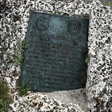 A close up of a bronze plaque in a rock
