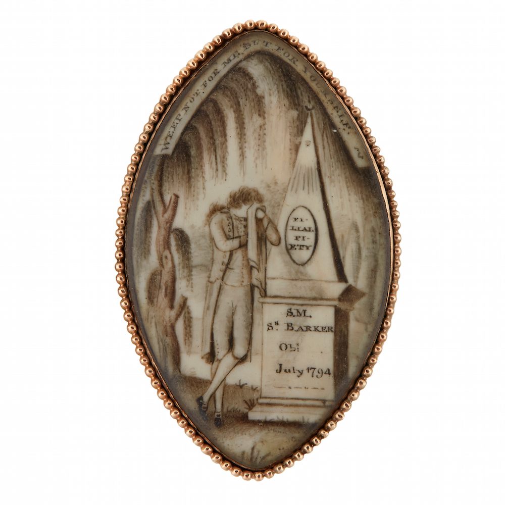 A mourning pin, depicting a male mourner weeping beside obelisk inscribed, "FI-/ LIAL/ PI-/ ETY." Probably from America, dated 1794.