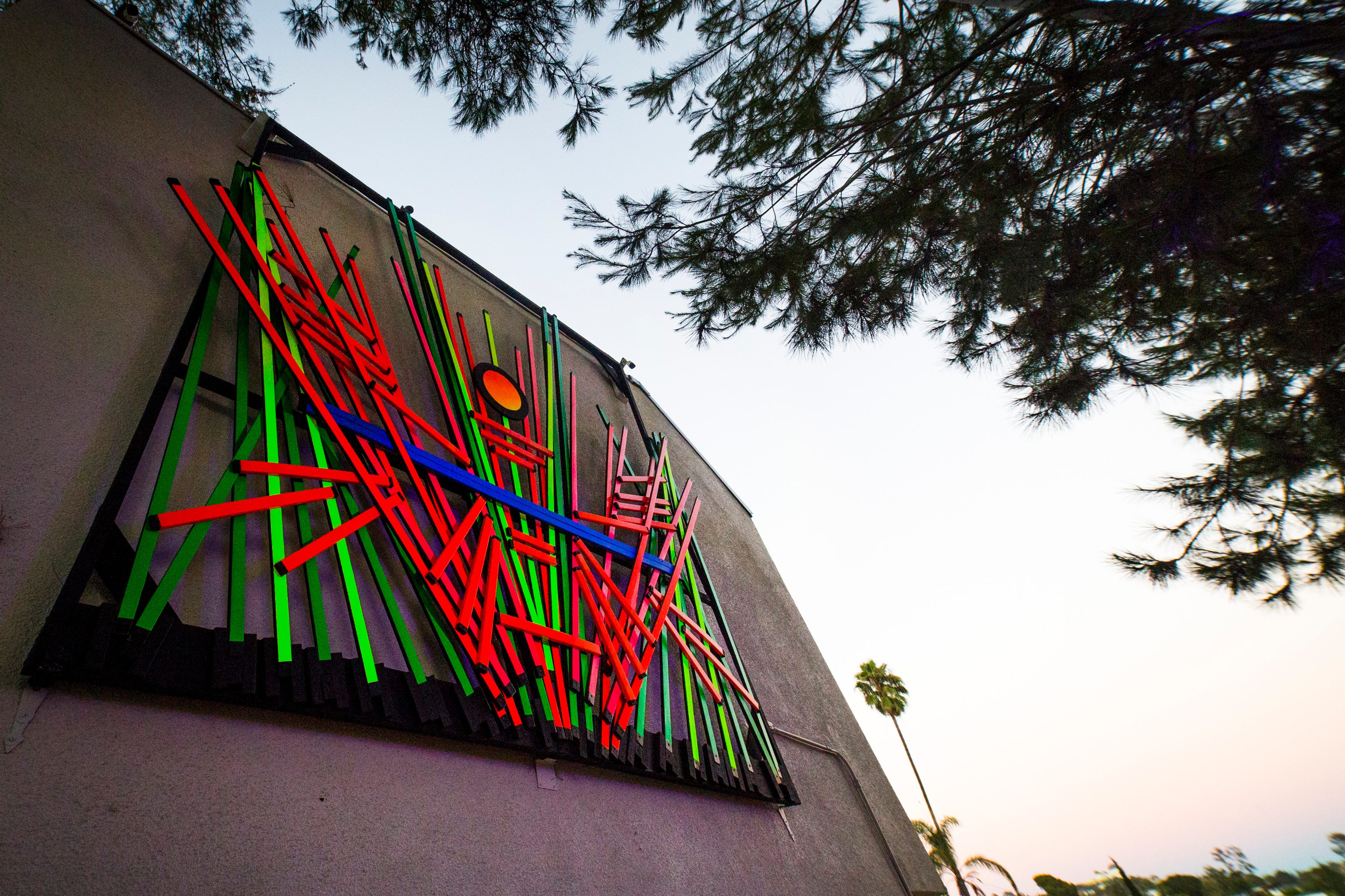 A neon-colored wall sculpture imitates its environs. 