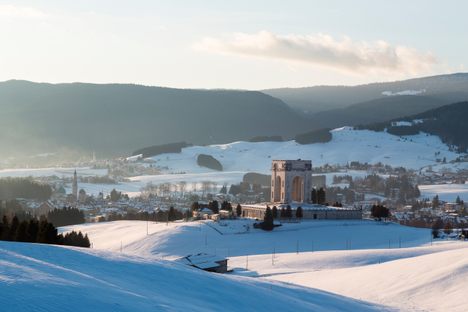 The memorial surrounded by the winter landscape.