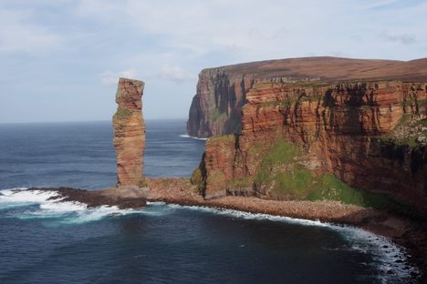 A teeny climber on top of the Old Man of Hoy.