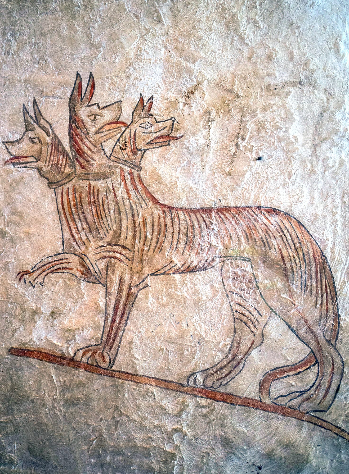 The painting of Cerberus below the mysterious inscription might hold a clue to its meaning. 