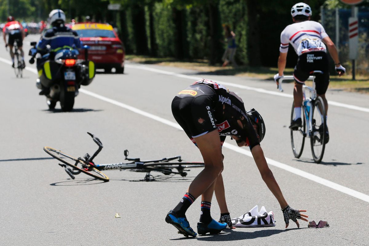 Warren Barguil of France recovers from a feed-zone crash in 2015. He was rifling through his musette when his bike hit a loose water bottle.