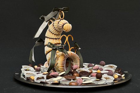 From the cavity of this florid horn emerges dozens of petit fours and chocolates in a bountiful display of plenty.