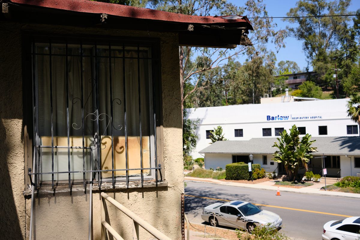 The modern Barlow Respiratory Hospital can be seen from the area of bungalows that have fallen into disuse.