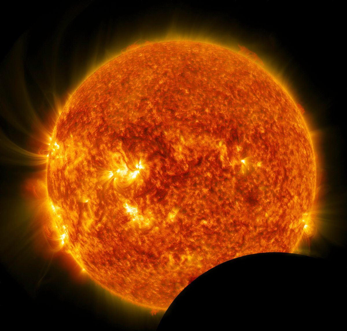 The temperature of the Sun's surface is about 5,600 degrees Celsius (10,000 degrees Fahrenheit). That's hot, but nowhere near the temperature needed to cook electrons off iron.
