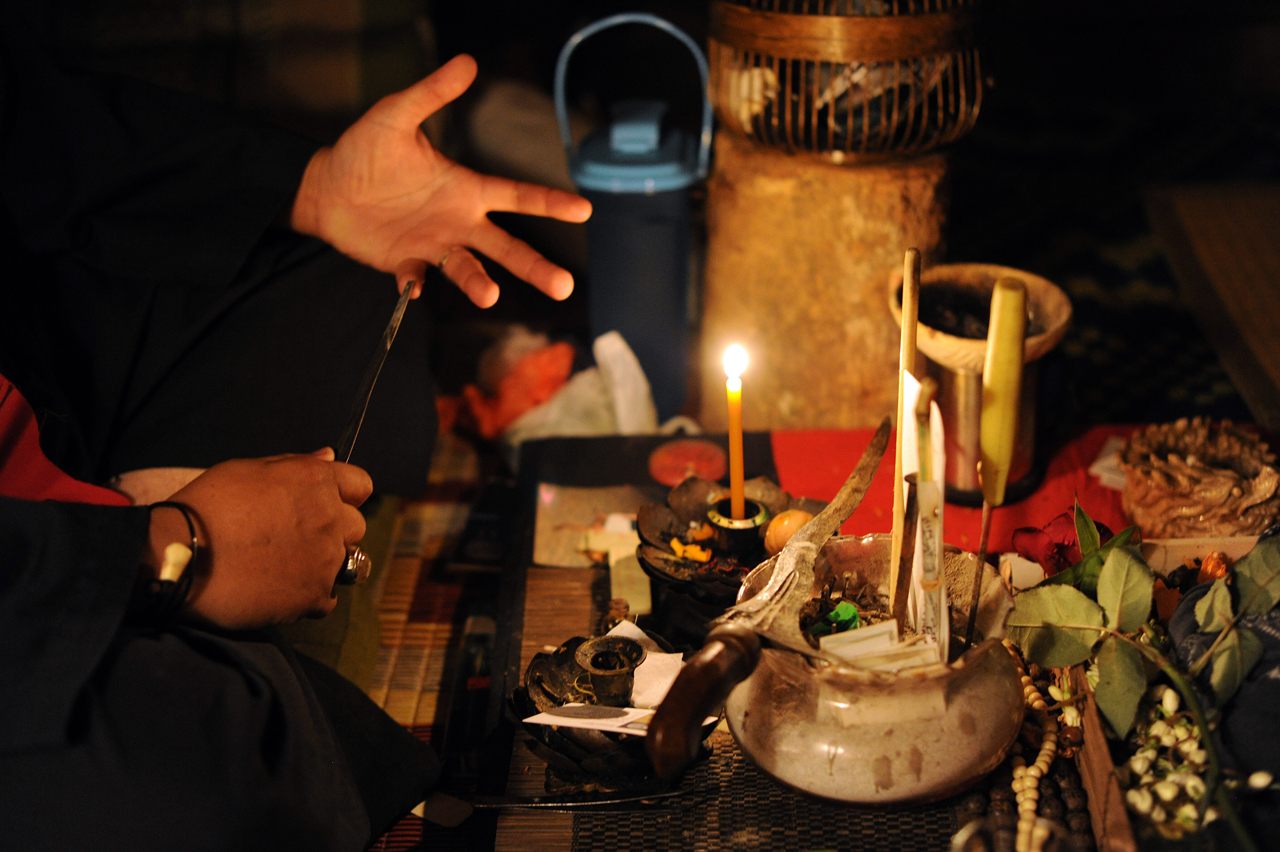 A Malay <em>bomoh</em>, or medium with the paraphernalia he uses to treat illnesses. The occult is popular in Malaysia, despite Islamic prohibitions against it. 