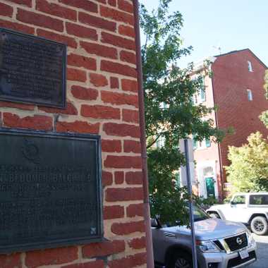 The plaque in foreview, with JFK's green doorstep across the street.