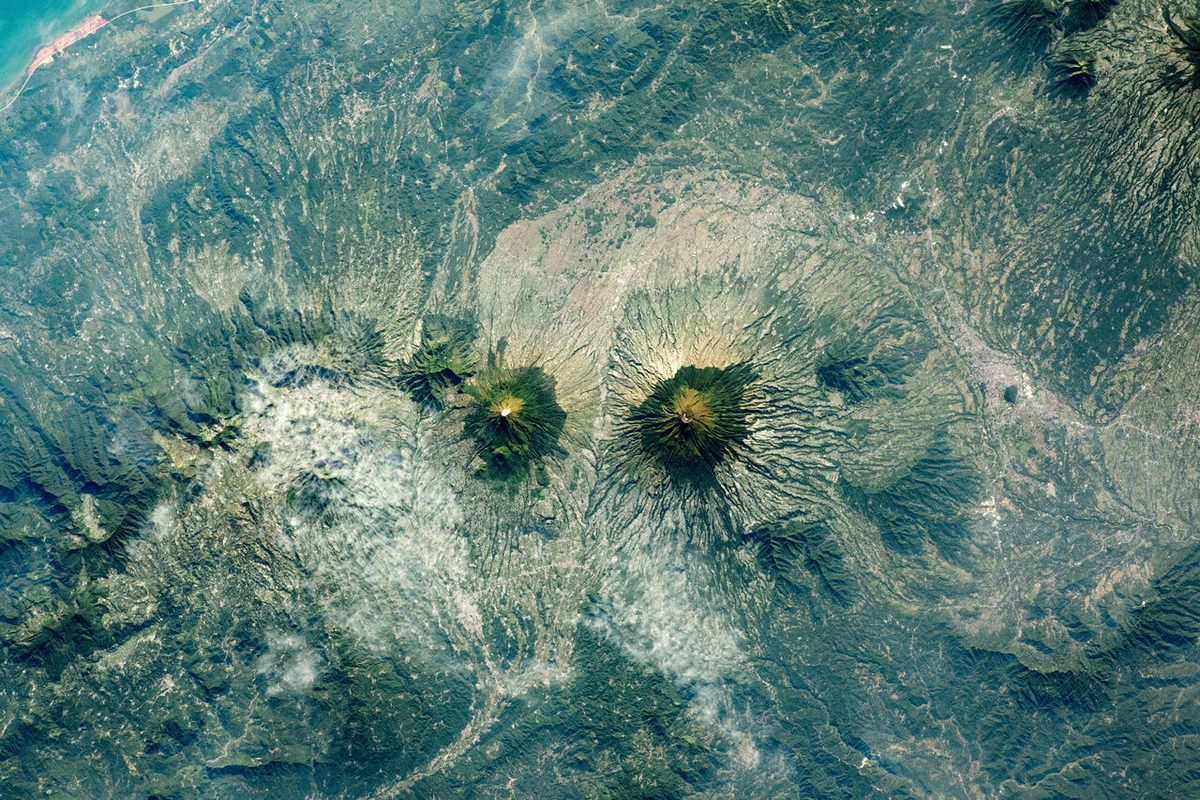 Seen from the International Space Station, twin volcanoes Sundoro and Sumbing (left to right) on the Indonesian island of Java.