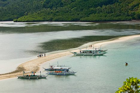 Boats pulling up to Snake Island in the El Nido archipelago.