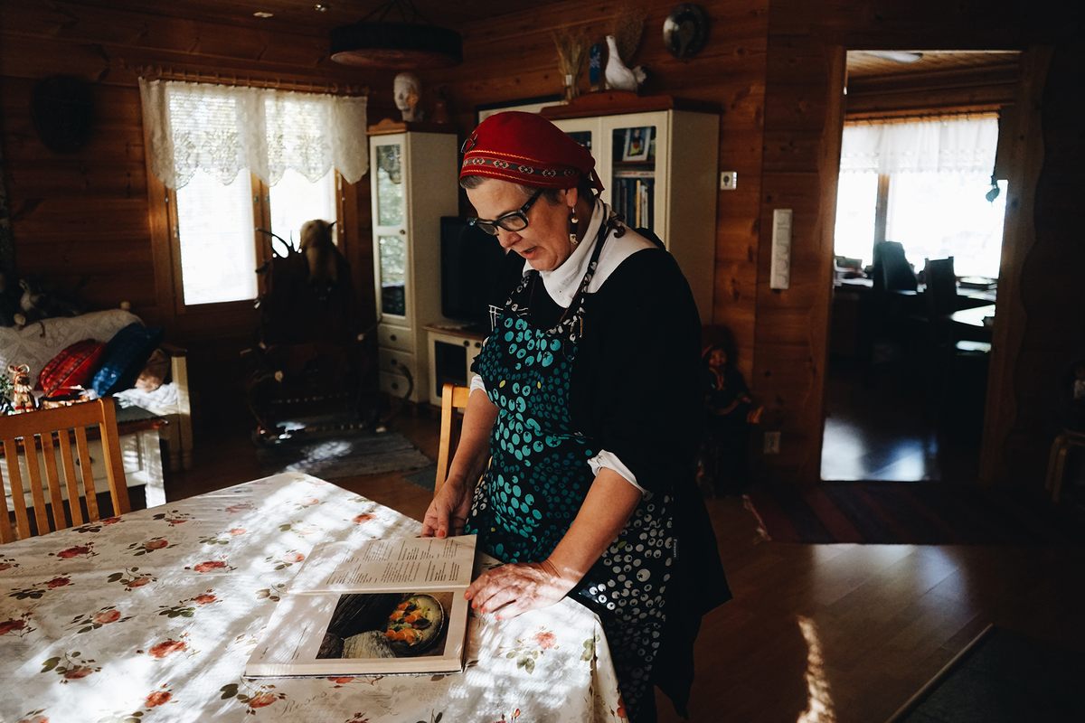 Kangasniemi takes out a vintage Arctic cuisine cookbook, <em>Lapin Klokia</em>. This book is one of her most treasured possessions.