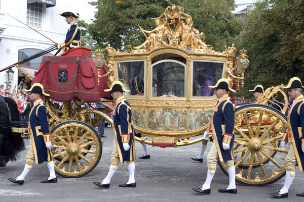 The Golden Coach, pictured here moving through The Hague, has inspired conversations about what to do with artifacts of the colonial era. 
