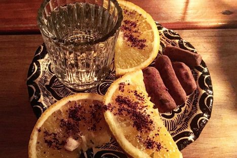 Pox is often served with coffee ground–dusted orange slices and a few pieces of cacao.