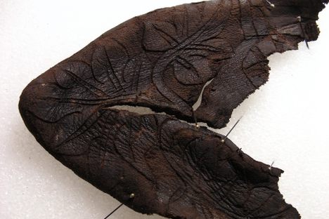 The floral-etched toe of the baby boot.