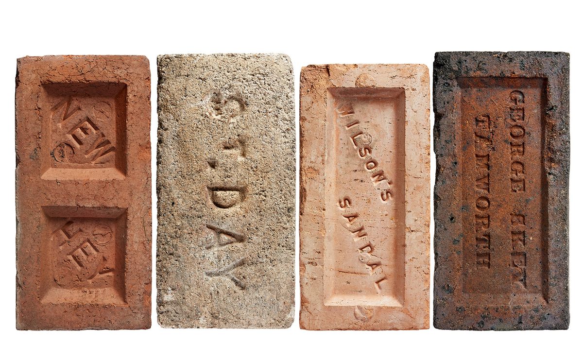 Bricks are often stamped with names and insignias that are hidden against a wall.