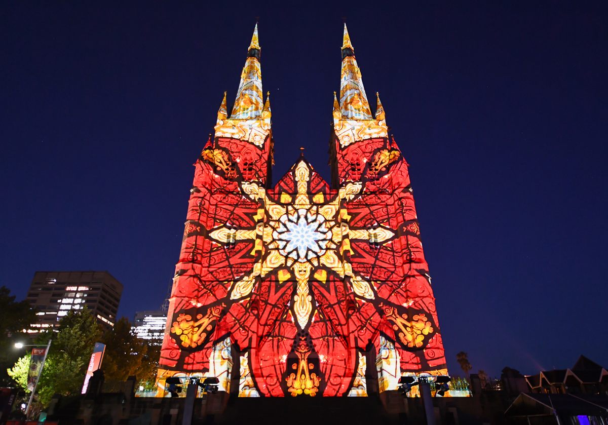 Projections of stained glass illuminate the facade of St. Mary's Cathedral in Sydney, Australia.