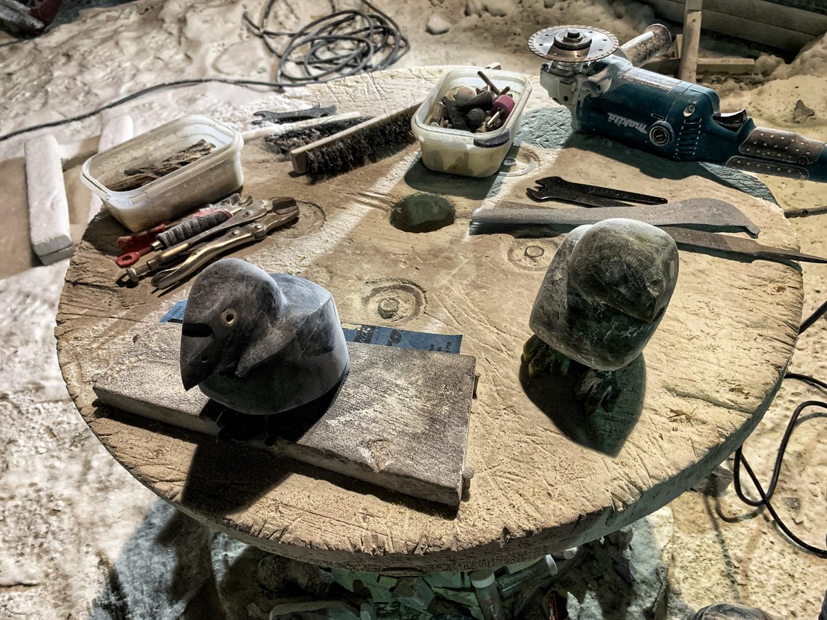 This outdoor table has become a carving station for Elijah Jonah, an incarcerated artist.