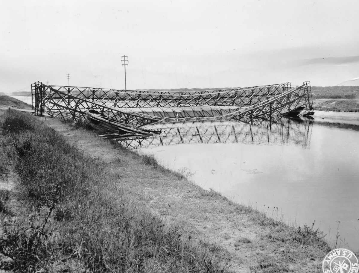 A dummy bridge built out of canvas and burlap. It was partially destroyed by Germans who saw it above the city of Pisa.