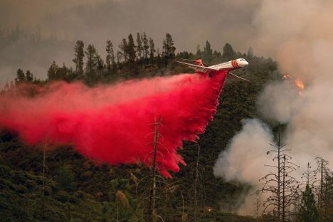 An air tanker drops retardant to help contain the Ferguson fire in Stanislaus National Forest.