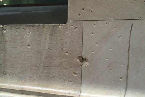 Touch a Wall Street building scarred by a 1920 terrorist bombing.