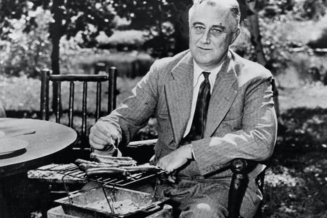 Franklin Delano Roosevelt roasting hot dogs. They smell like diplomatic breakthroughs.