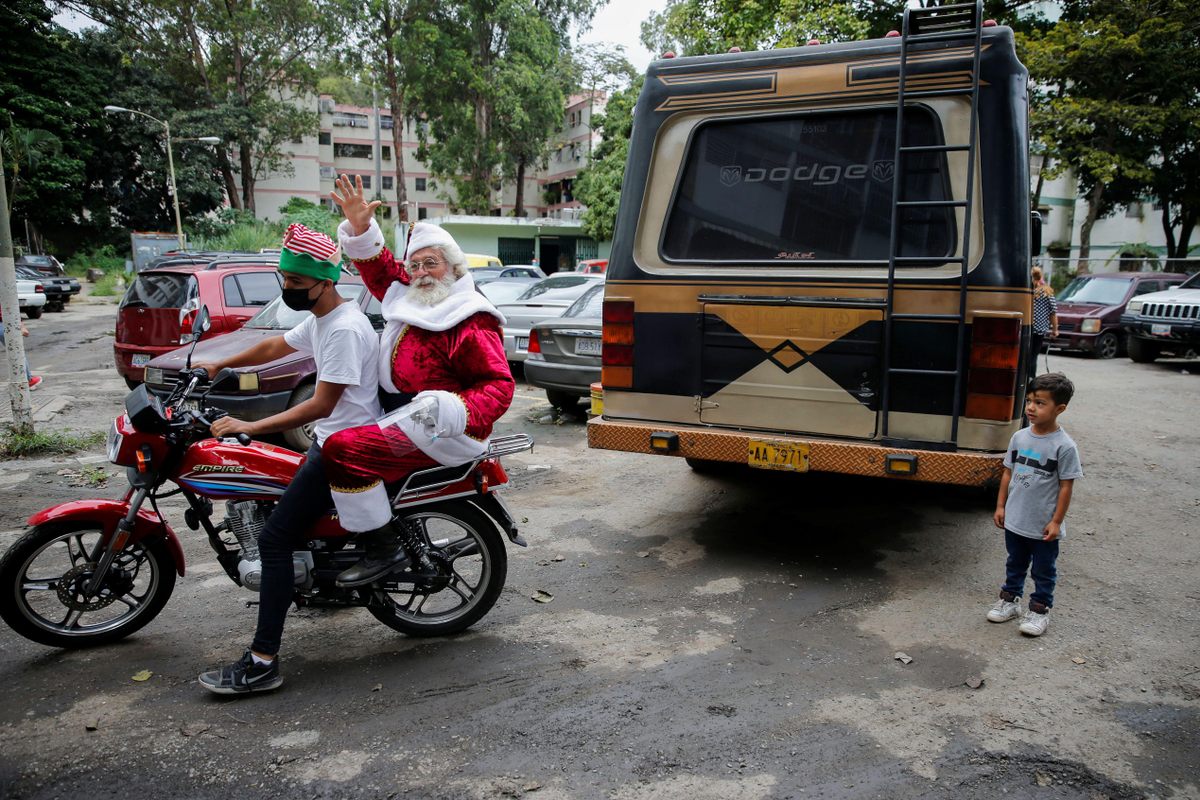 A man dressed as Santa Claus distributes toys in Caracas on behalf of a Venezuelan journalists group, in 2021.