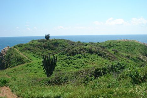 The slight outline of the military fort can be seen atop Punta Cometa.