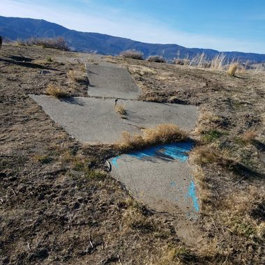 Tip of the arrow, looking back west.  The skylined mountains are Boca Ridge in California.  The blue paint is _not_ original.