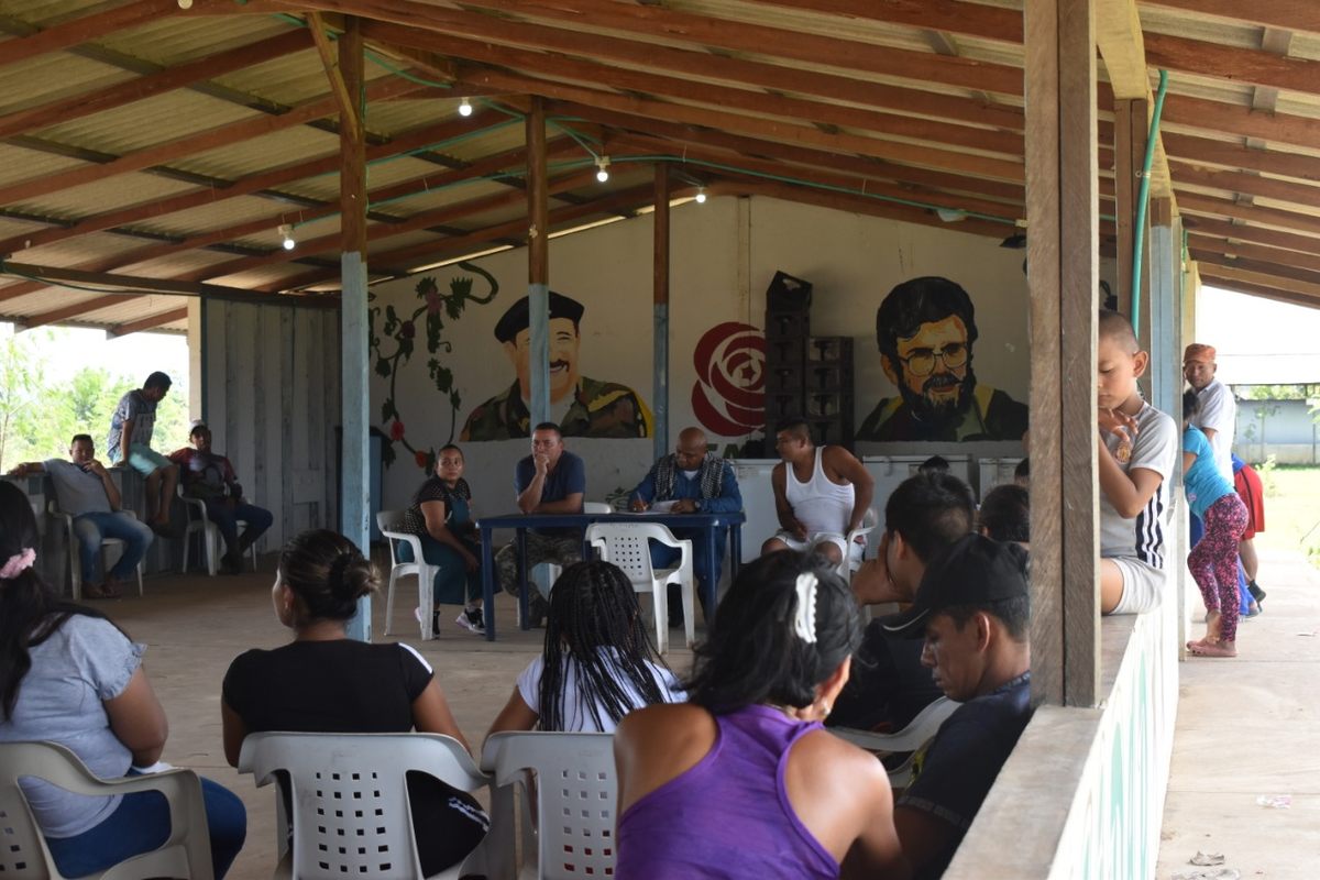 Semillas (center, writing at the desk) leads a bi-monthly assembly at the Comunidad Noble y de Paz Marco Aurelio Buendía, where decisions are made collectively.