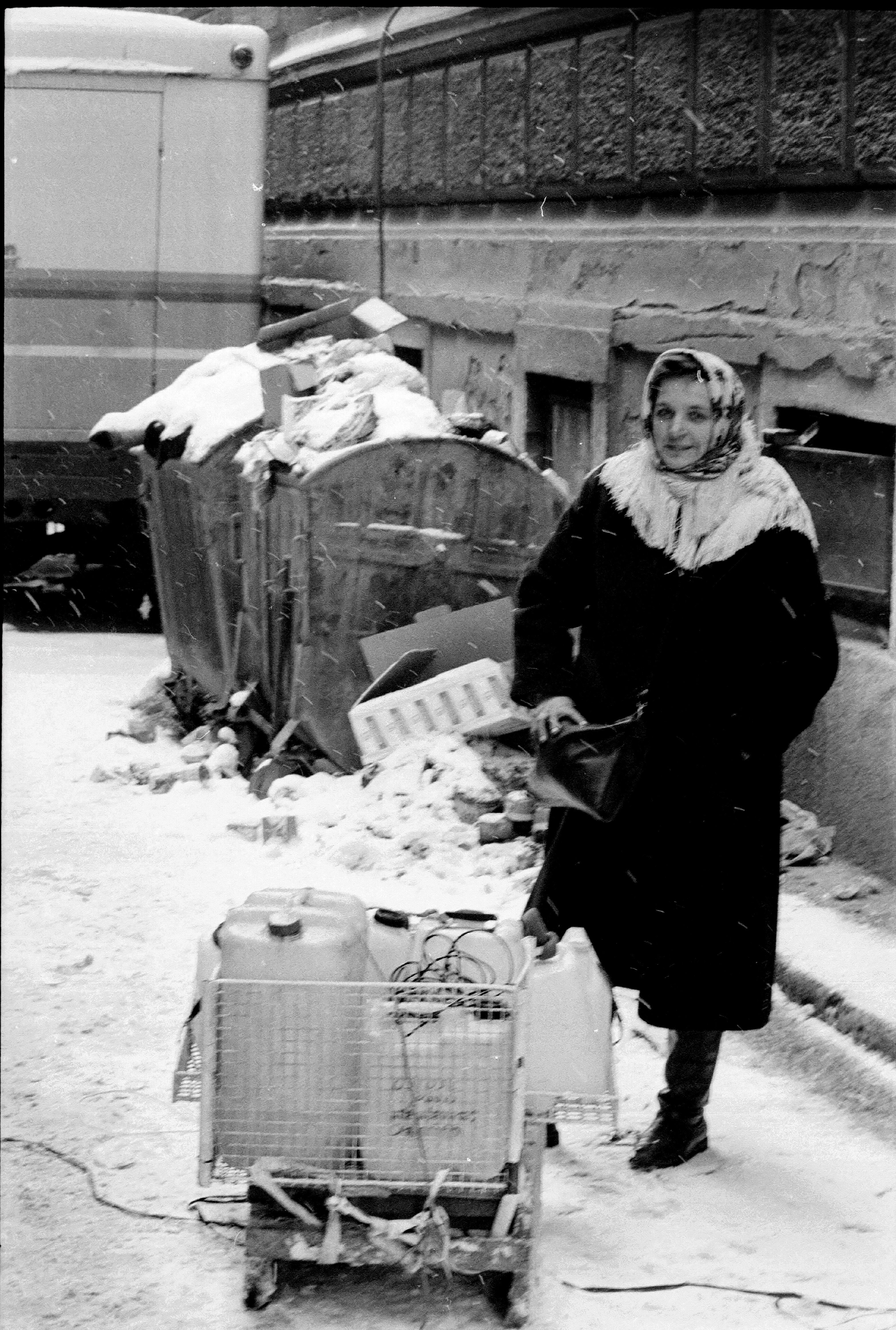 A woman, pictured in 1993, filling up jugs of water in Sarajevo.