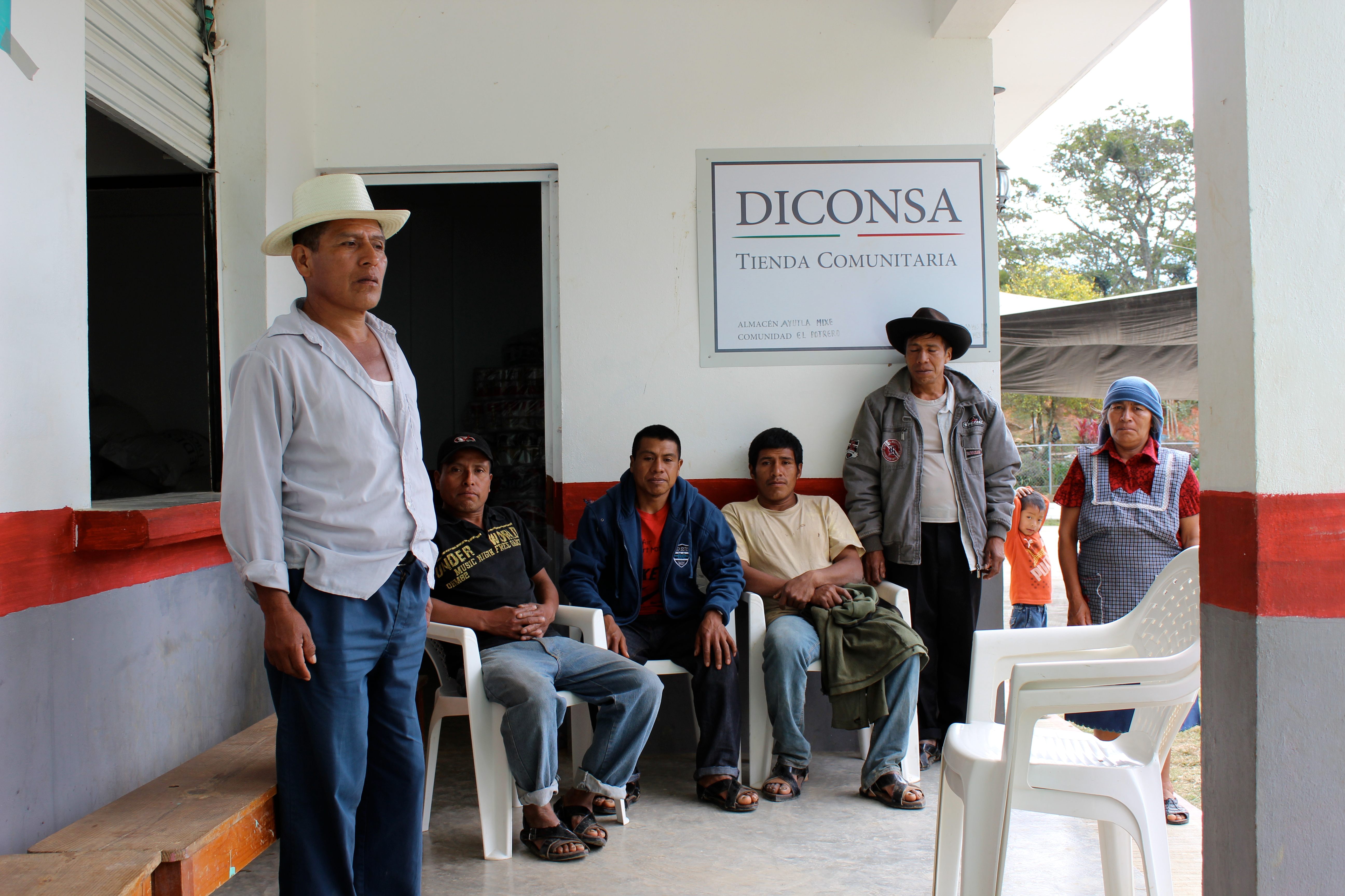 Townspeople gather in a courtyard near a school.