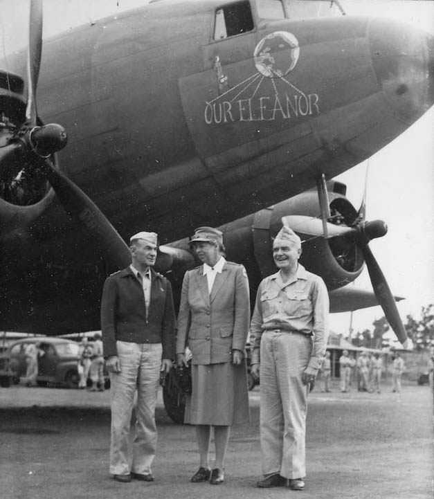 Eleanor with Lt. General Millard F. Harmon (left) and Admiral William F. Halsey in front of a plane decorated in her honor by the U.S. Army Air Forces 13th Troop Carrier Squadron on New Caledonia.