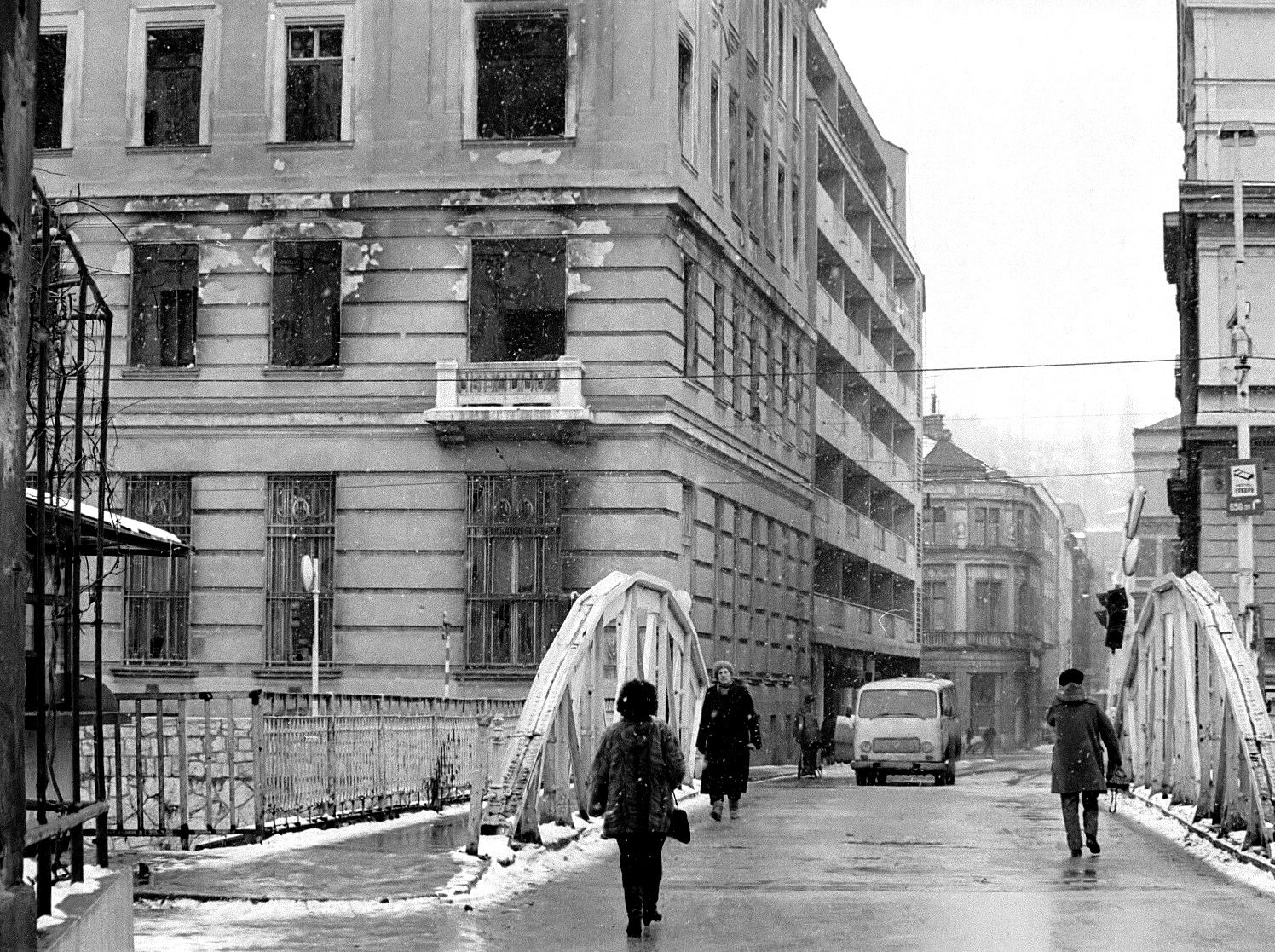 People cross the Miljacka River during the siege.