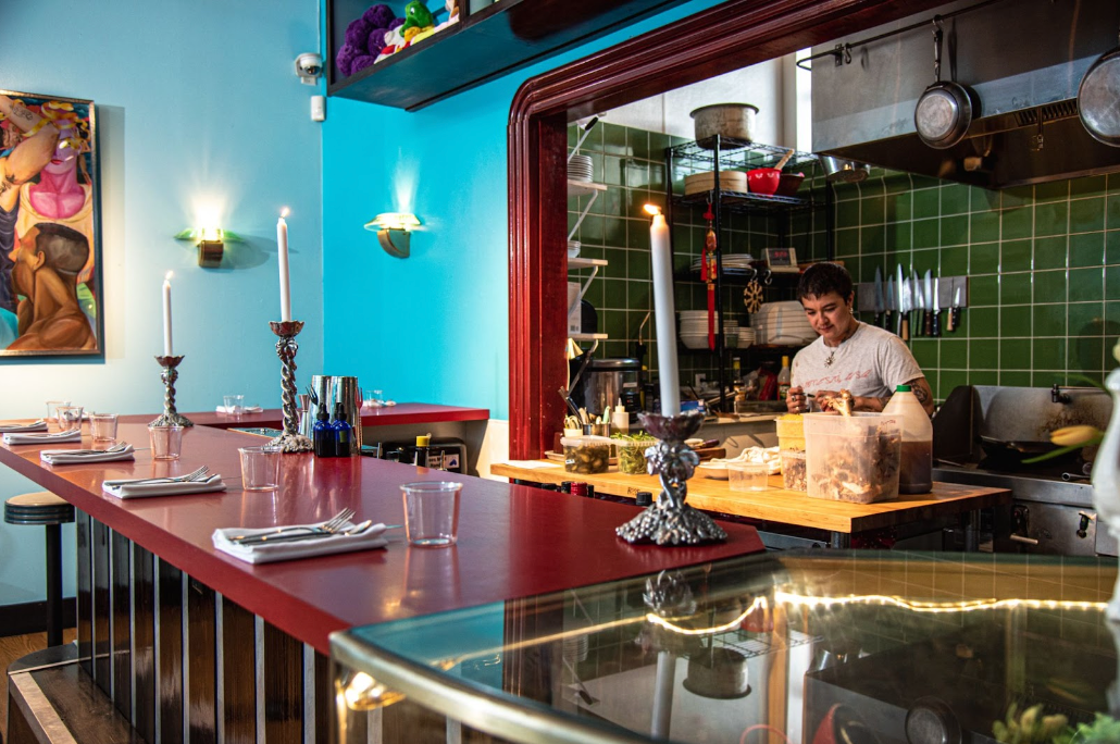 Neng Jr.'s L-shaped bar overlooks the restaurant’s open kitchen.