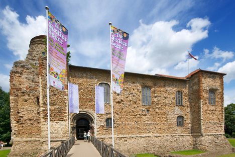 Colchester Castle with brickwork of the podium exposed in the front.