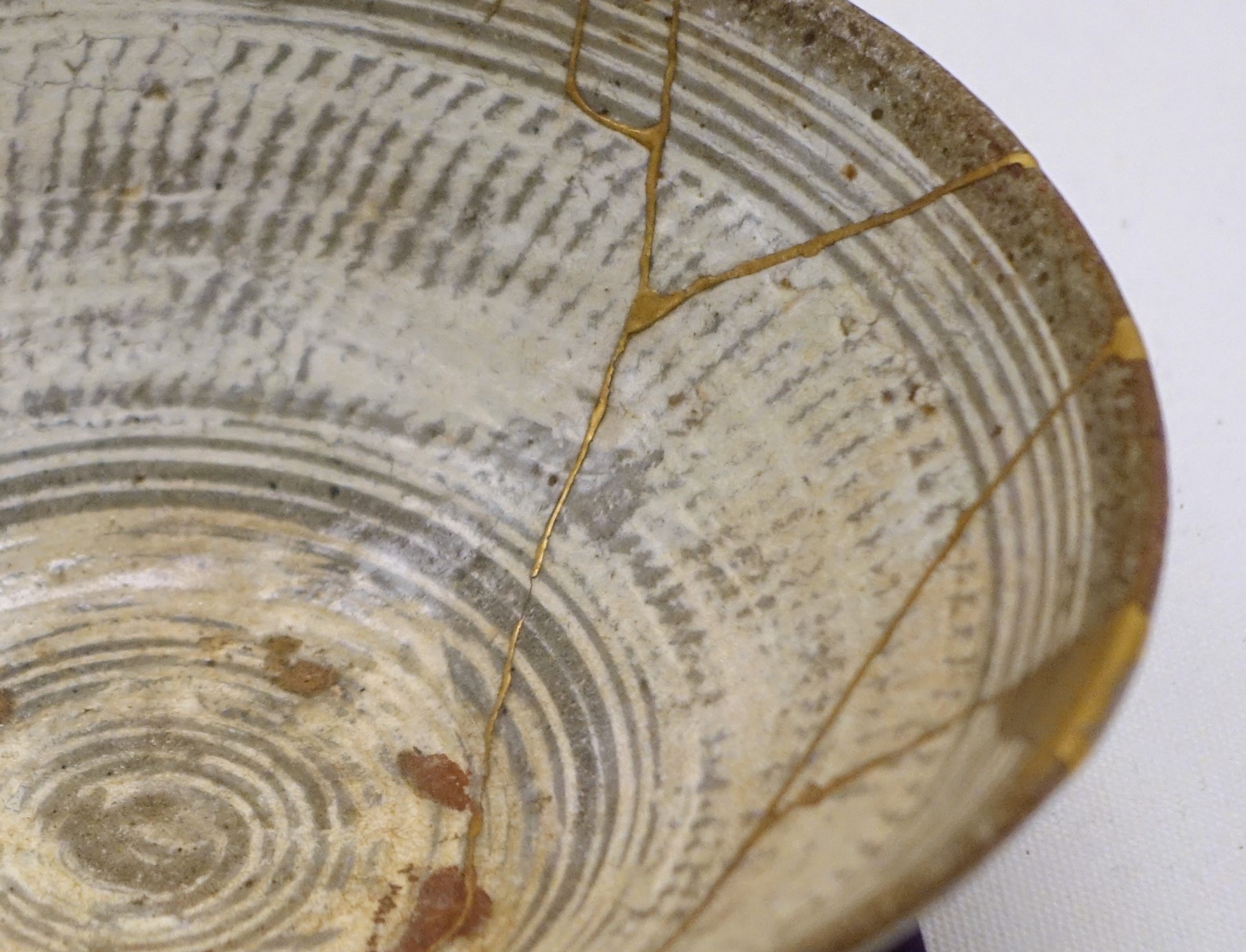 Kintsugi bowl with cracks, tablware, ceramics. Japanese technique