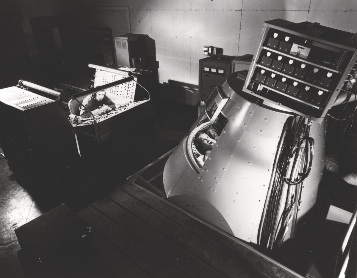 John Glenn runs through a training exercise in the Mercury Procedures Trainer at the Space Task Group at Langley Field, 1960.