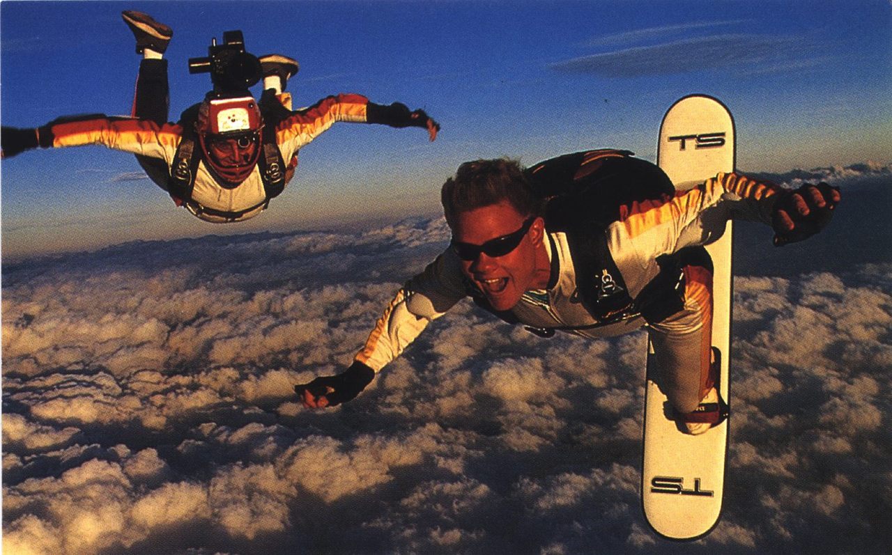 Troy Hartman surfs the skies as his cameraman flies by his side. 