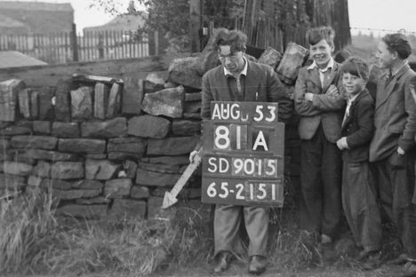 An Ordnance Survey worker points his arrow at a revision point, while laughing children look on. 