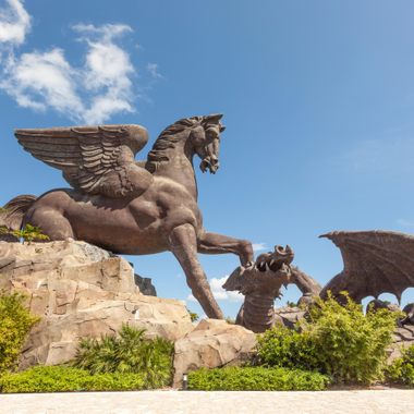 Pegasus crushes a dragon beneath his hooves.