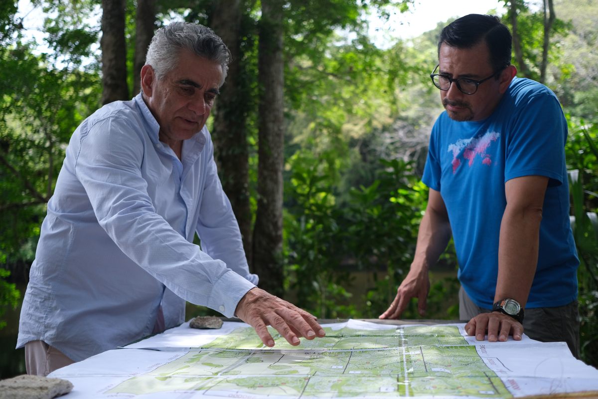 Gerardo Ceballos and Heliot Zarza Villanueva study a map of the Calakmul Biosphere.