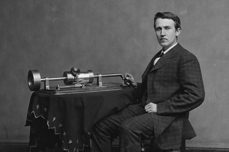 Edison poses by his phonograph in a photograph from 1878.