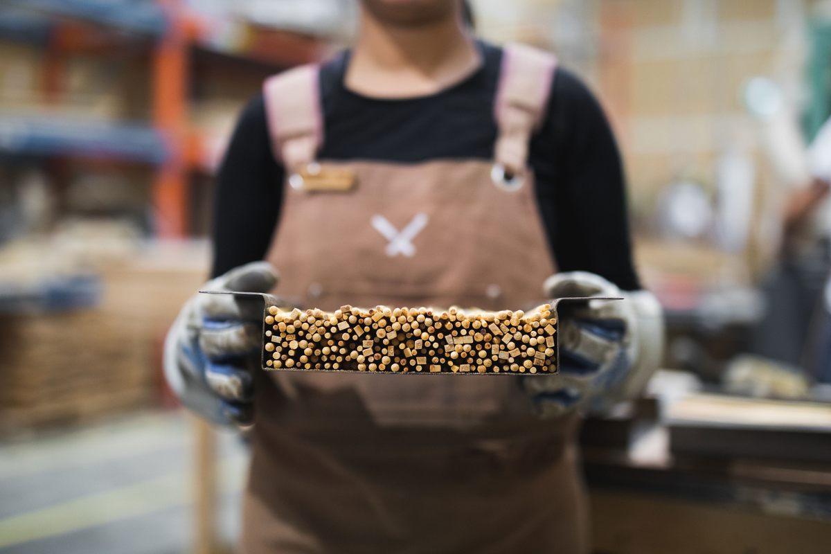 An employee holding chopsticks ready for compression.