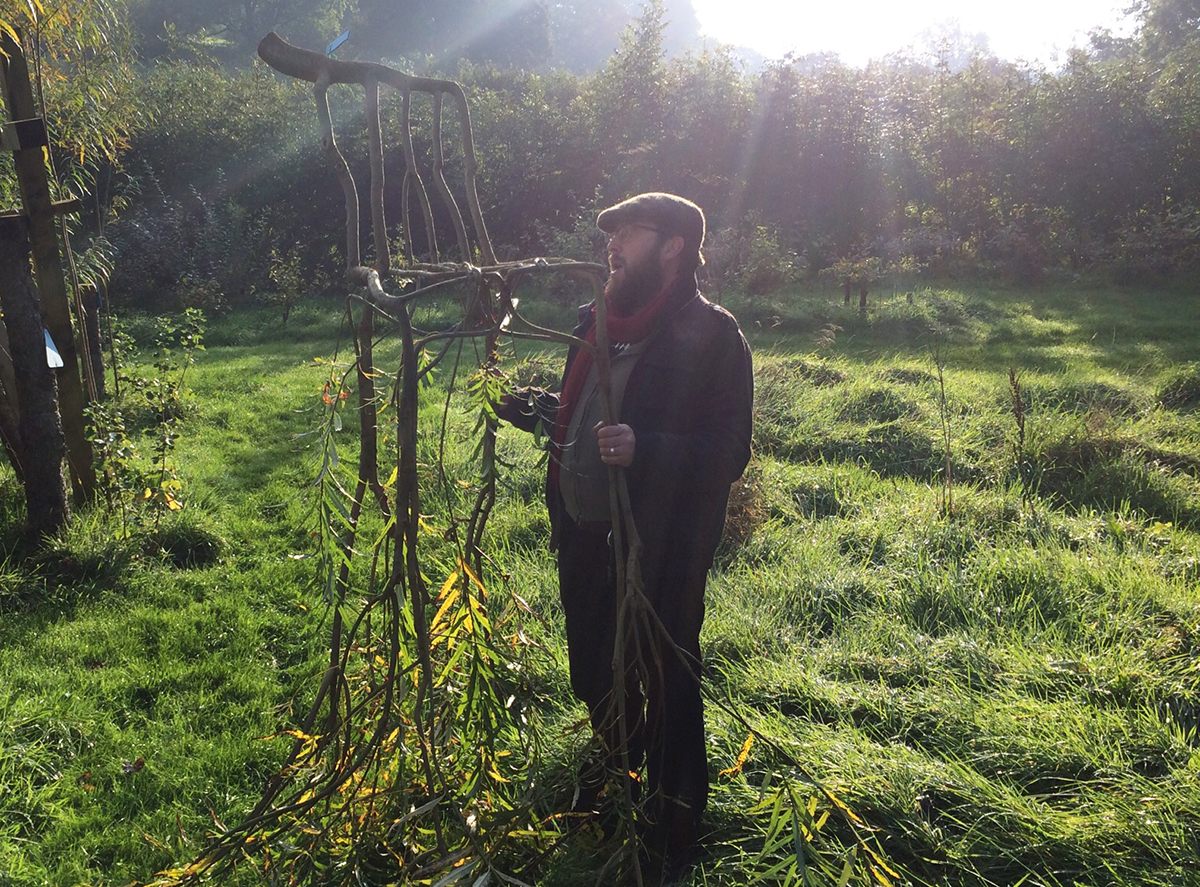 Gavin Munro in a field with a chair.