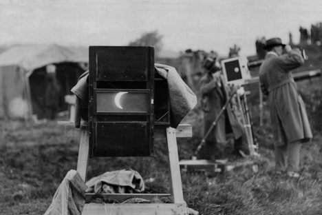 A partially eclipsed sun seen through a large camera during the 1927 solar eclipse over Giggleswick, England.